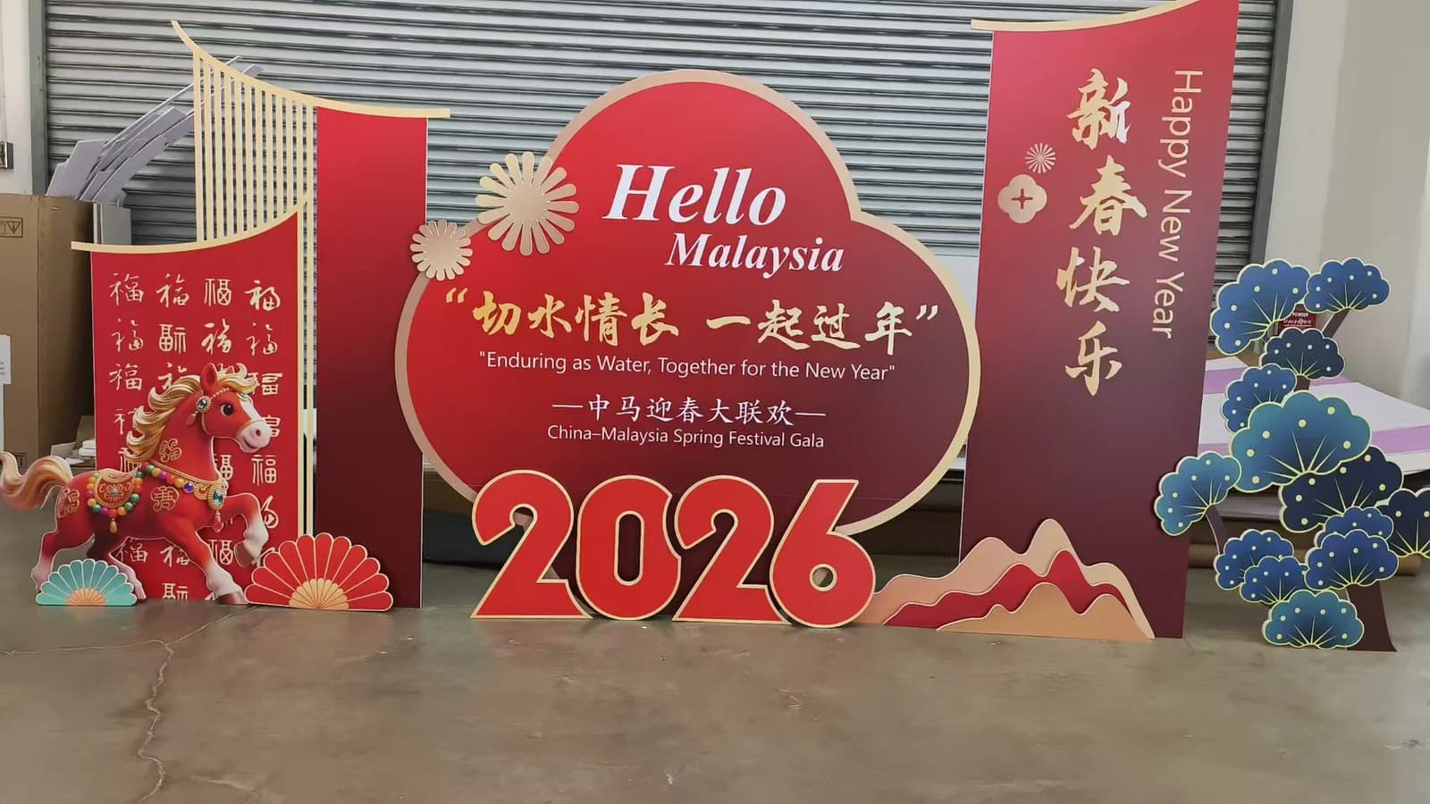 Freestanding red Hello Malaysia Spring Festival event display with layered scenic elements