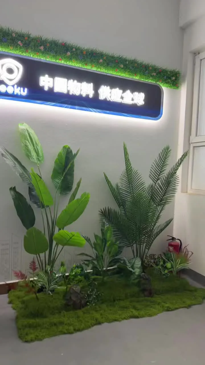 Illuminated office wall sign installed above a planted feature area