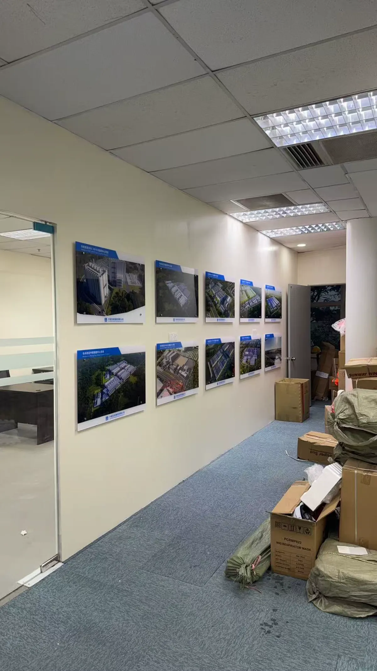 Office corridor gallery wall with a coordinated series of framed project images