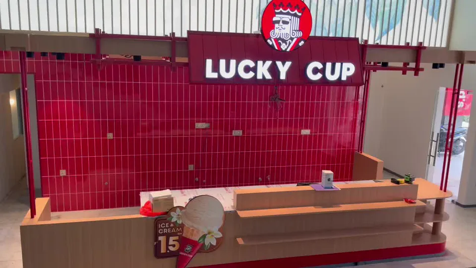 Completed Lucky Cup retail counter with illuminated fascia lettering and a red tiled feature wall